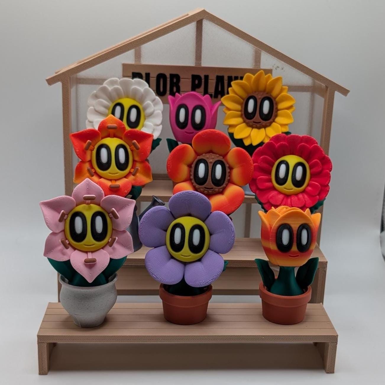 Colorful flower-shaped toys with cartoon faces on a wooden stand.