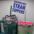 Two tumblers with personalized straw toppers labeled 'David' and 'Sharon' on a light gray background.